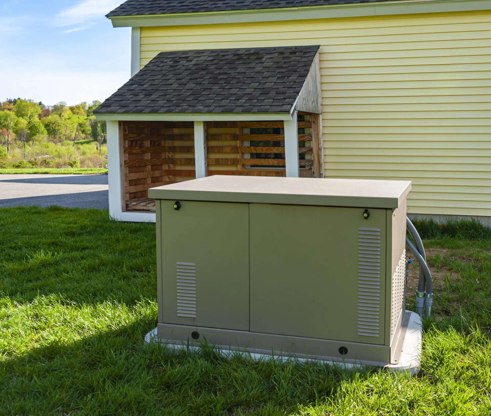 Outdoor air conditioning condenser next to a building wall